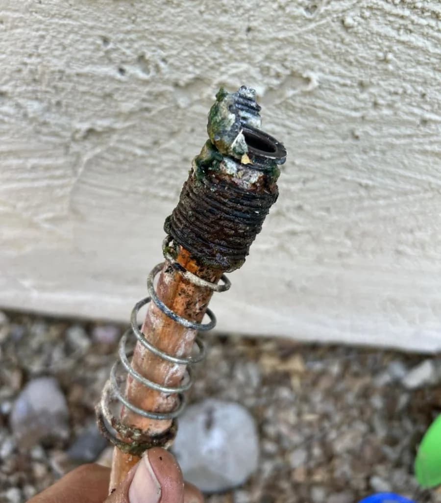 Removed hose bib showing severe corrosion and mineral buildup from Arizona hard water